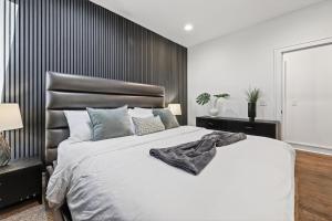a bedroom with a large bed with a black headboard at Luxury Condo - The Gulch - Private Rooftop in Nashville