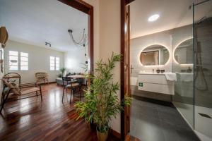 a bathroom with a glass shower and a sink at Sun & Roses in Funchal