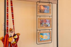 a group of framed pictures hanging on a wall at Sun & Roses in Funchal