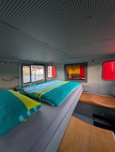 a bedroom in a train car with two beds at Oldtimer Camp Main Spessart in Collenberg +53 photos