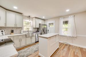 a kitchen with white cabinets and a counter top at Comfort and Convenience! Home 3 Mi to Dtwn Wilson in Wilson
