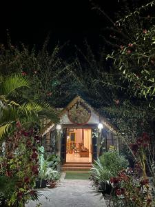 a house with a christmas wreath on the door at Lokosha Resort - The Green Destination in Hatikhuli
