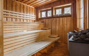 a wooden sauna with a bench and two windows at Lovely Home In Åre With Sauna in Härbyste +25 photos