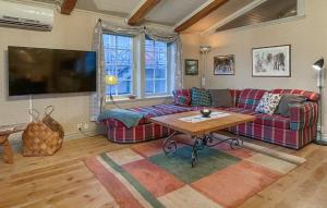 a living room with a couch and a table at Lovely Home In Åre With Sauna in Härbyste