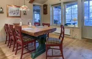 a dining room with a wooden table and chairs at Lovely Home In Åre With Sauna in Härbyste