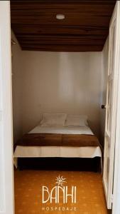 a bedroom with a bed in a room at Hospedaje Banhi in Líbano +3 photos
