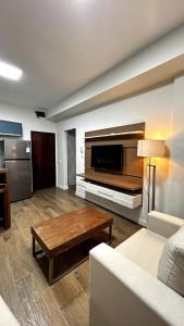 a living room with a couch and a coffee table at Flat Pé na Areia em Angra dos Reis RJ in Angra dos Reis