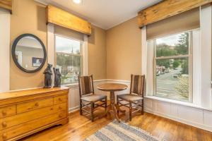 a room with a table and two chairs and a mirror at Cozy Cub Den in Bryson City