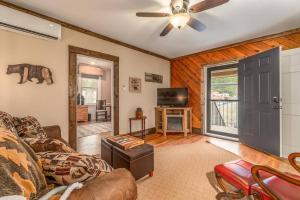 a living room with a couch and a ceiling fan at Cozy Cub Den in Bryson City