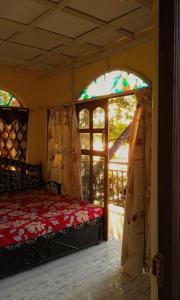 a bedroom with a bed and a window at RivoGoa riverside Homestay in Bardez