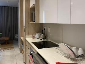 a kitchen with white cabinets and a black sink at Zimbali Lakes Boulevard Suites 145 in Ballito