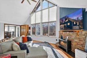 a living room with a couch and a fireplace at Dog-Friendly Chalet in The Woods Resort w Fire Pit in Baxter