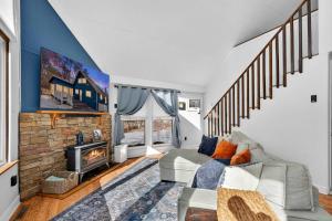 a living room with a couch and a fireplace at Dog-Friendly Chalet in The Woods Resort w Fire Pit in Baxter