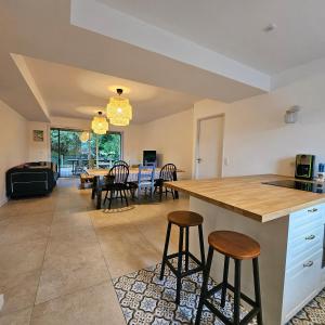 a kitchen and dining room with a table and chairs at La Litoise in Lit-et-Mixe