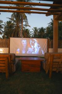 a large screen with a woman on top of it at Villa Loui Beach Icaraizinho-Ce in Icaraí +31 photos