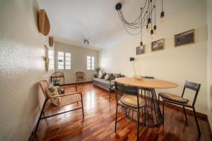 a living room with a table and chairs and a couch at Sun & Roses in Funchal