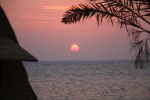 ein Sonnenuntergang über dem Meer mit der Sonne am Himmel in der Unterkunft Nakhlat E'taal Camp - نخلة التل كامب in Nabq + 32 Fotos