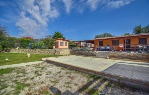 a yard with a building and a playground at Lovely Home In Civitavecchia in Aurelia