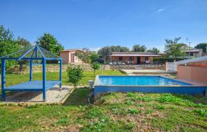 a swimming pool in a yard with a gazebo at Lovely Home In Civitavecchia in Aurelia