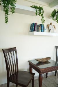 une table, une chaise et une étagère à livres dans l'établissement New 2 Bedroom Huge Beachfront Patio in San Pedro Town, à San Pedro