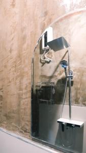 a mirror on the wall of a bathroom at O-ya Homestay in General Luna