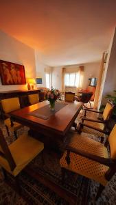 a living room with a wooden table and chairs at Villa dei Pini in Laveno-Mombello +15 photos
