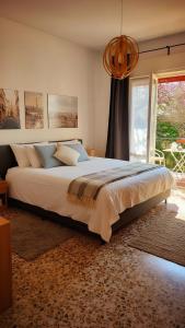a large bed in a bedroom with a window at Villa dei Pini in Laveno-Mombello