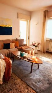 a living room with a couch and a coffee table at Villa dei Pini in Laveno-Mombello