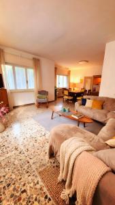 a living room with a couch and a table at Villa dei Pini in Laveno-Mombello