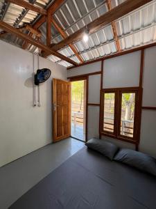 an empty room with a window and a door at Modo home in Komodo +17 photos