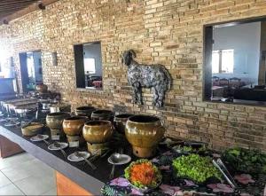 a table with a bunch of food on it at Monte Castelo Flat Temporada in Gravatá
