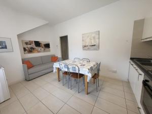 eine Küche und ein Esszimmer mit Tisch und Stühlen in der Unterkunft Residence Equilio Family Apartments in Lido di Jesolo