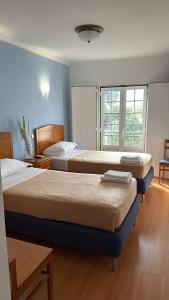 Postel nebo postele na pokoji v ubytování Hospedaria Canto do Rossio