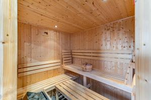 a wooden sauna with benches and a bucket in it at Magnificent Getaway - Tennis, Climbing & More! in Backwell