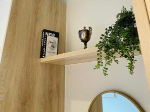 a wooden shelf with a clock and a book at Zimbali Lakes Boulevard Suites 145 in Ballito