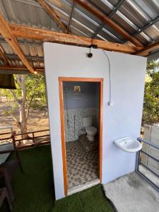 a bathroom with a toilet inside of a building at Modo home in Komodo