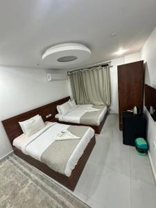 Ένα ή περισσότερα κρεβάτια σε δωμάτιο στο prince pyramids view