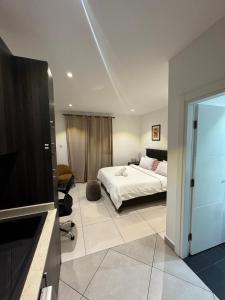 a bedroom with a bed and a flat screen tv at Luxury Sid Apartments in Accra