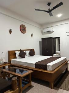 a bedroom with a bed and a ceiling fan at Lokosha Resort - The Green Destination in Hatikhuli +25 photos
