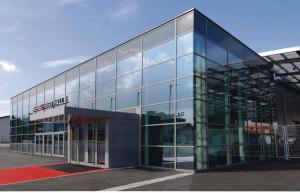 un edificio de cristal con un cartel en el costado en ModernLoft Ried, Balcony Suite, en Neuhofen im Innkreis