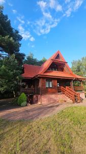 a log cabin with a red roof at Magiczny Dom nad Bugiem  +26 photos