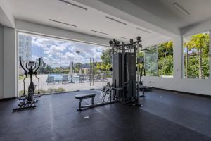 a gym with two tread machines and a large window at Fortunity Club- Playa Dorada, Pto Plata in Sampiño