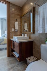 a bathroom with a sink and a mirror at Fortunity Club- Playa Dorada, Pto Plata in Sampiño