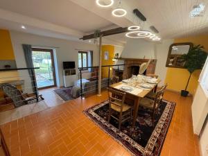 a living room with a table and a fireplace at Gîte La Chaumine in Brangues