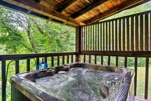 a hot tub sitting on a screened in porch at Bluff Mountain's Private Retreat in Sevierville +41 photos