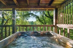 a hot tub on the porch of a house at Bluff Mountain's Private Retreat in Sevierville