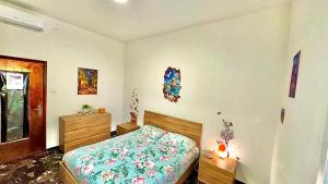 a bedroom with a bed and a dresser at Eden Guesthouse in Bologna