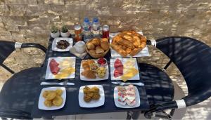 a table with many plates of food on it at Rizkian pyramids view INN in Cairo