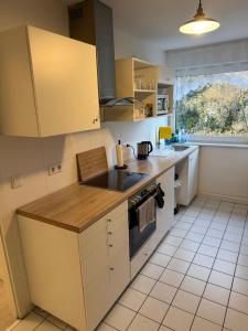 a kitchen with yellow cabinets and a counter top at Monteurzimmer Schölerpad in Essen +2 photos
