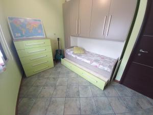 a small bedroom with a small bed and a dresser at Al 28в, Appartamento Teulada in Teulada